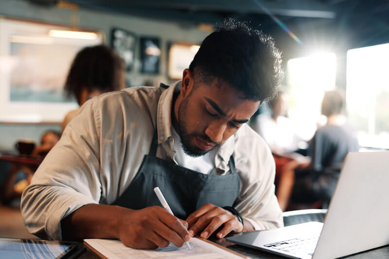 A young man completes a tax form.